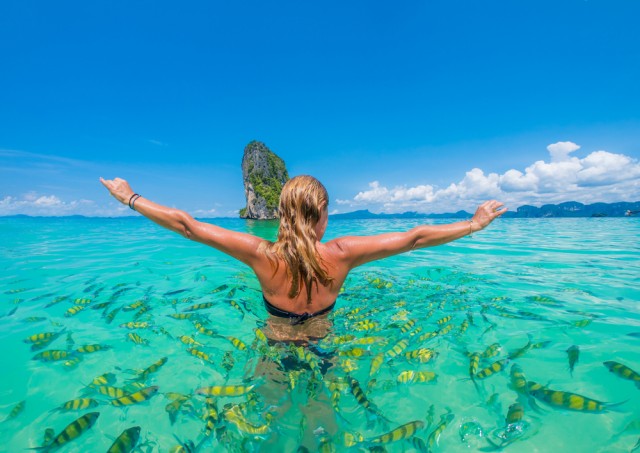 Woman,Swimming,With,Snorkel,Surrounded,By,Fish,,Andaman,Sea,,Thailand